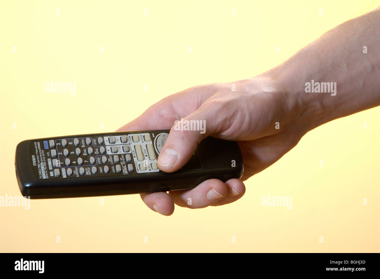 Man holding a remote control Stock Photo - Alamy