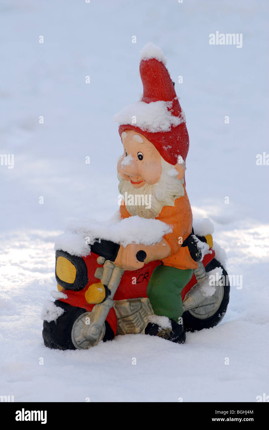 GNOME SITTING ON MOTORBIKE IN SNOWY CONDITIONS,UK Stock Photo