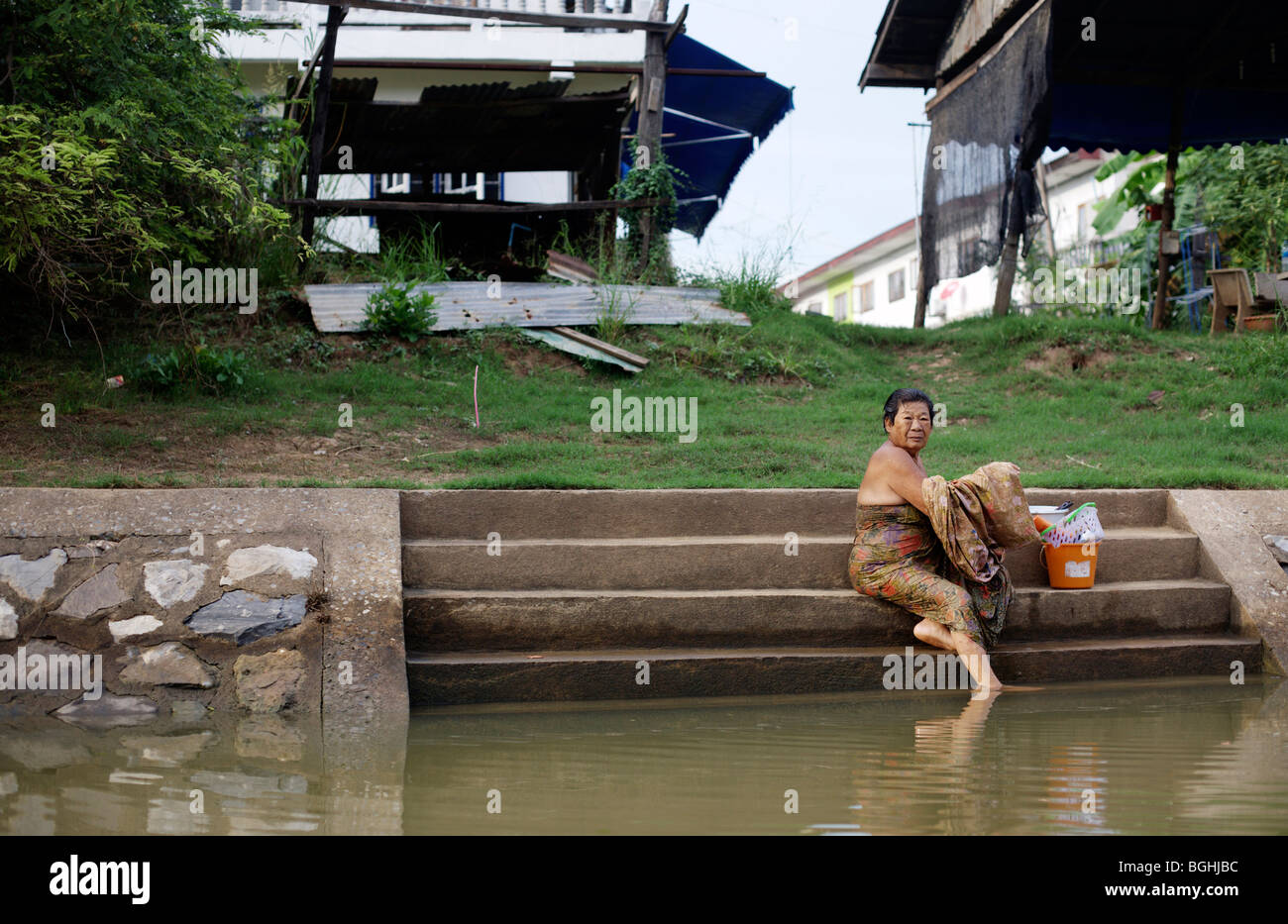 A woman bathes in the river in Ayuthaya or Ayutthaya in central Thailand Stock Photo