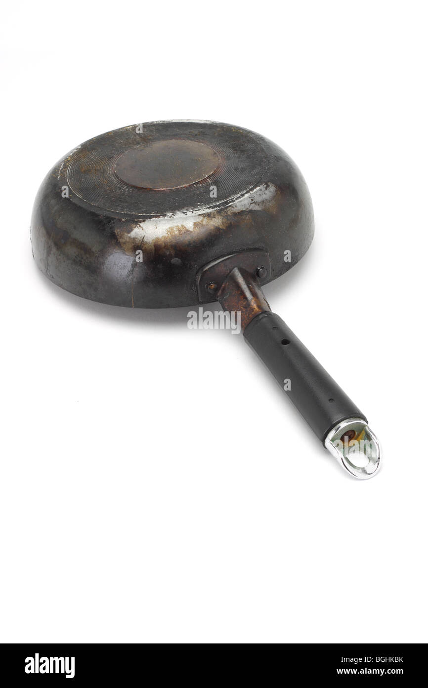 Old rusty frying pan inverted on white background Stock Photo - Alamy