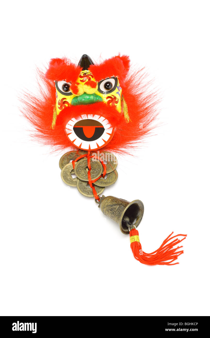 Chinese New Year ornaments lion head, gold coins and bell on white Stock Photo