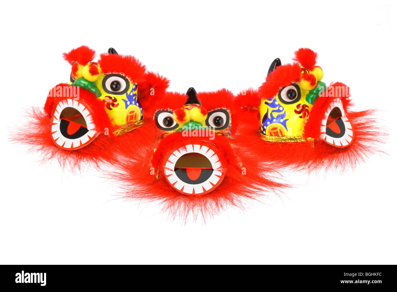 Three Chinese new year lion head ornaments arranged on white Stock Photo