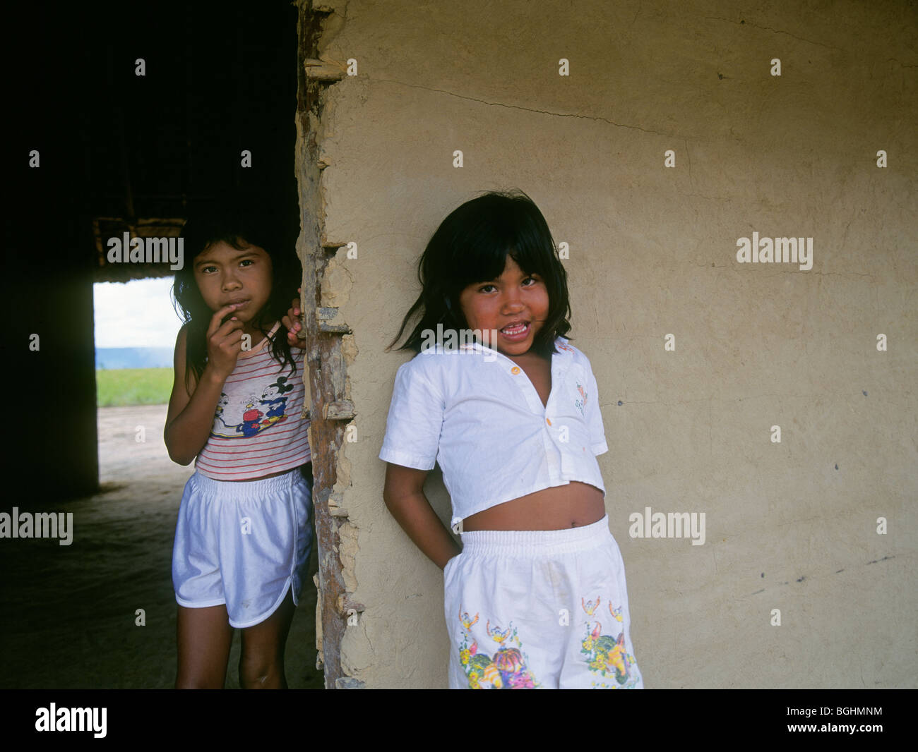 Two young Pemon Indian girls in their hut in a village in the Gran Sabana of Venezuela Stock Photo