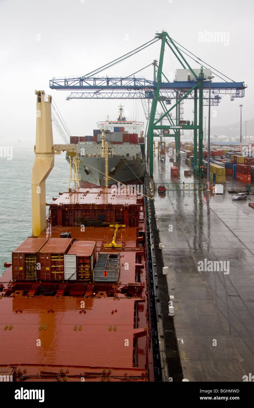 Container ships alongside quay on a rainy day Stock Photo