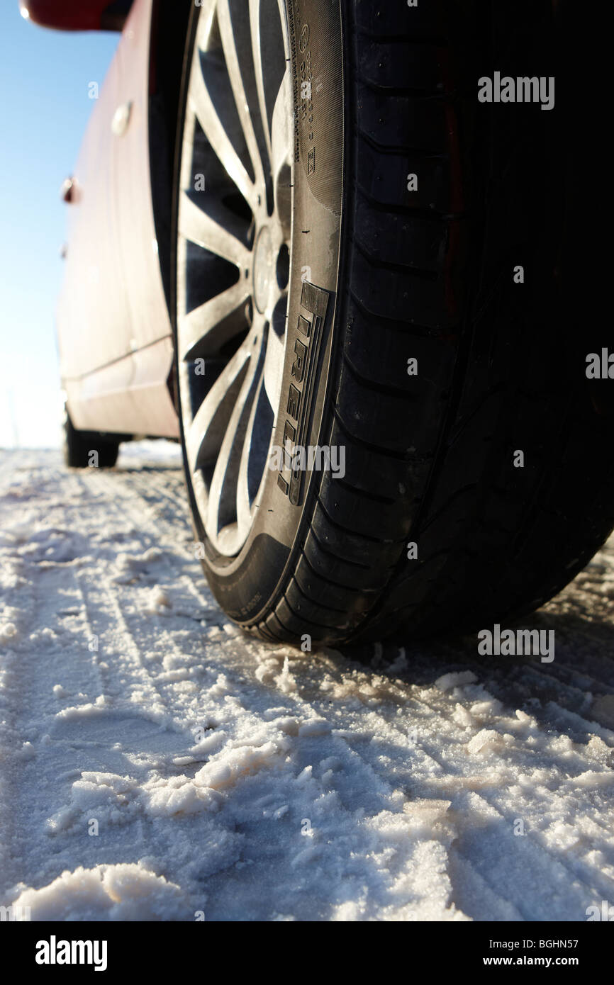 Close up of a Pirelli tyre and alloy wheel in the snow Stock Photo