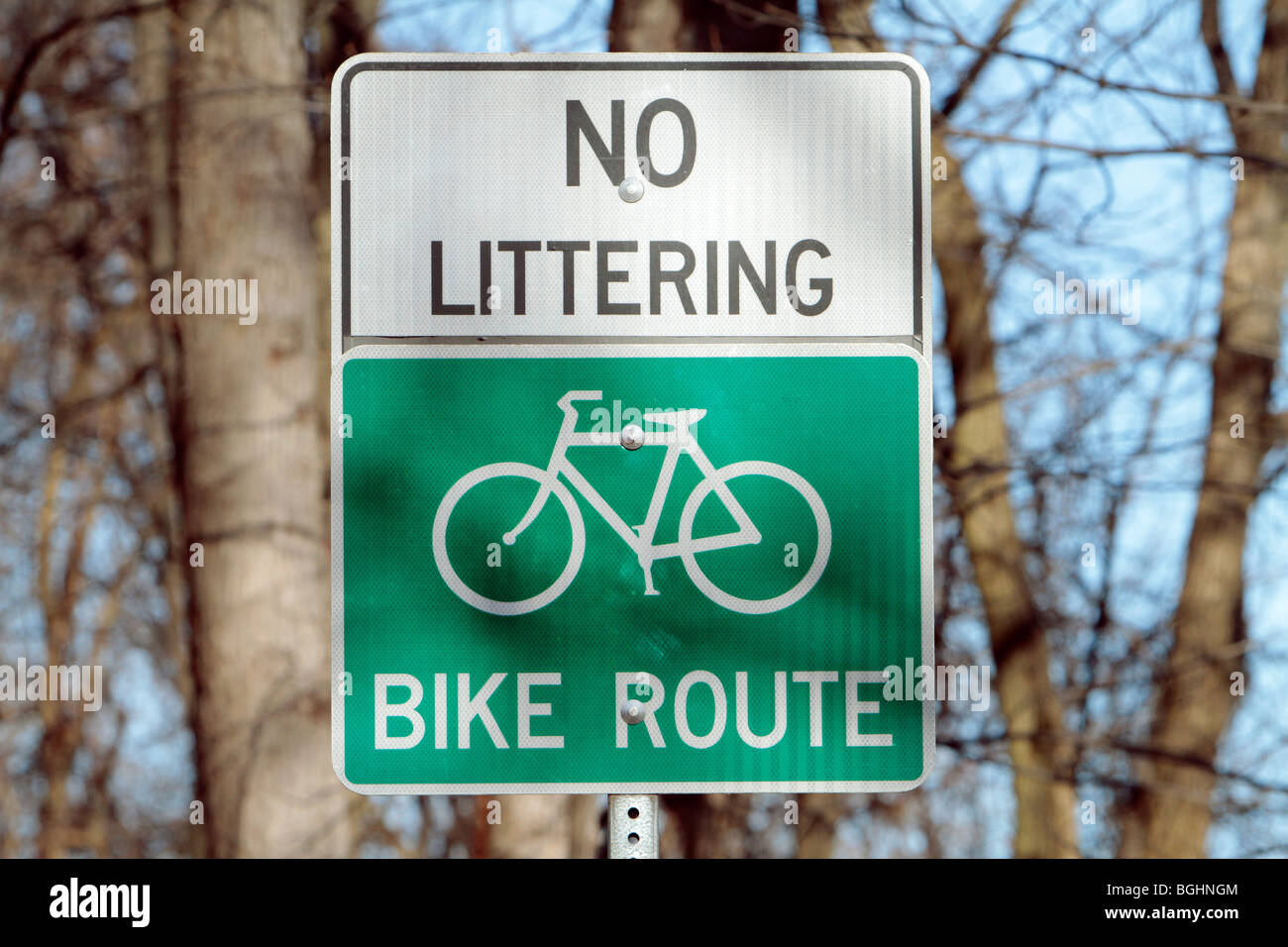 No Littering and bike route sign in the park. Stock Photo