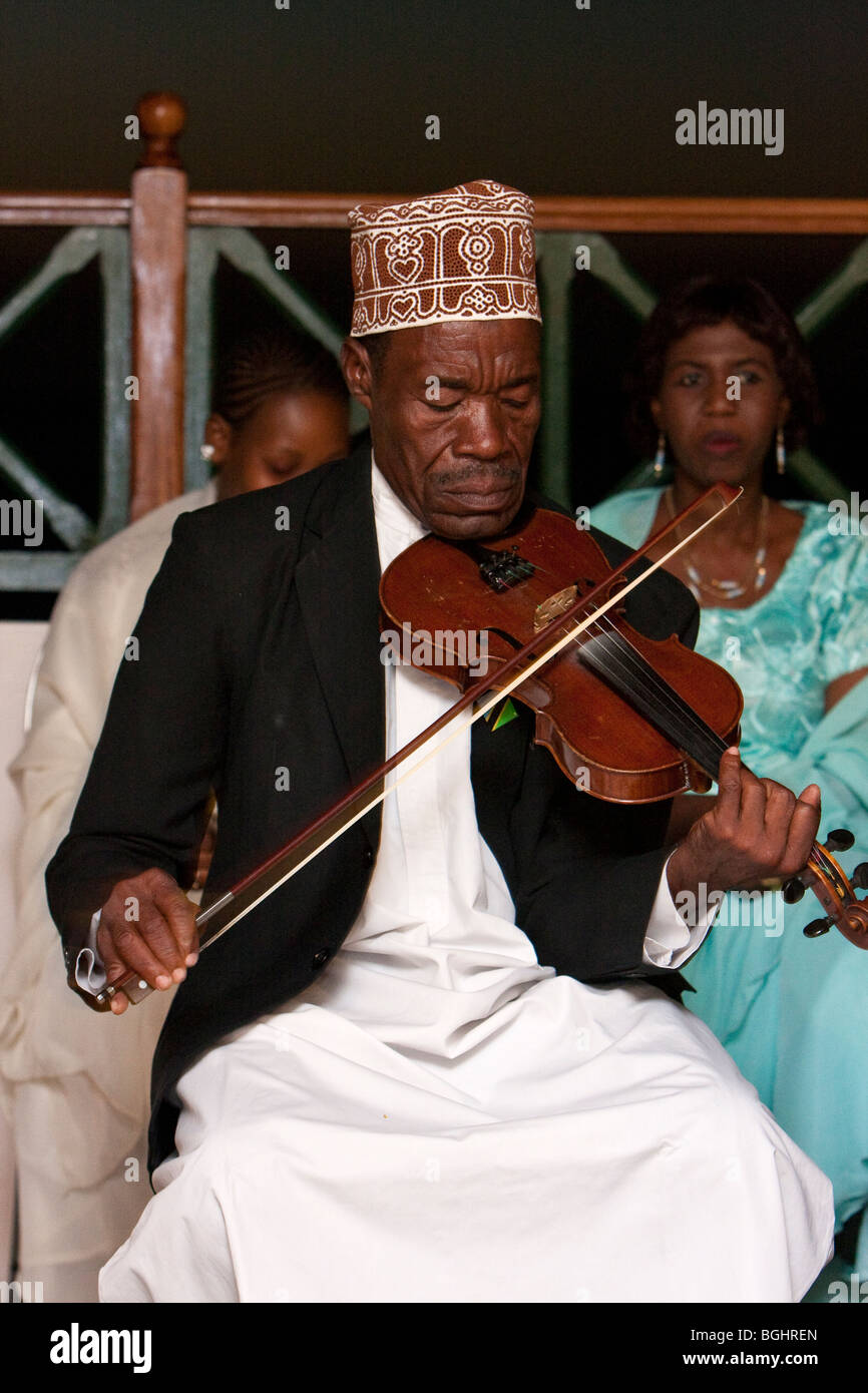 Zanzibar, Tanzania. Taarab Musicians. Culture Musical Club. Violin Player, Makame Faki, wearing a traditional Zanzibari hat, a kofia. Stock Photo