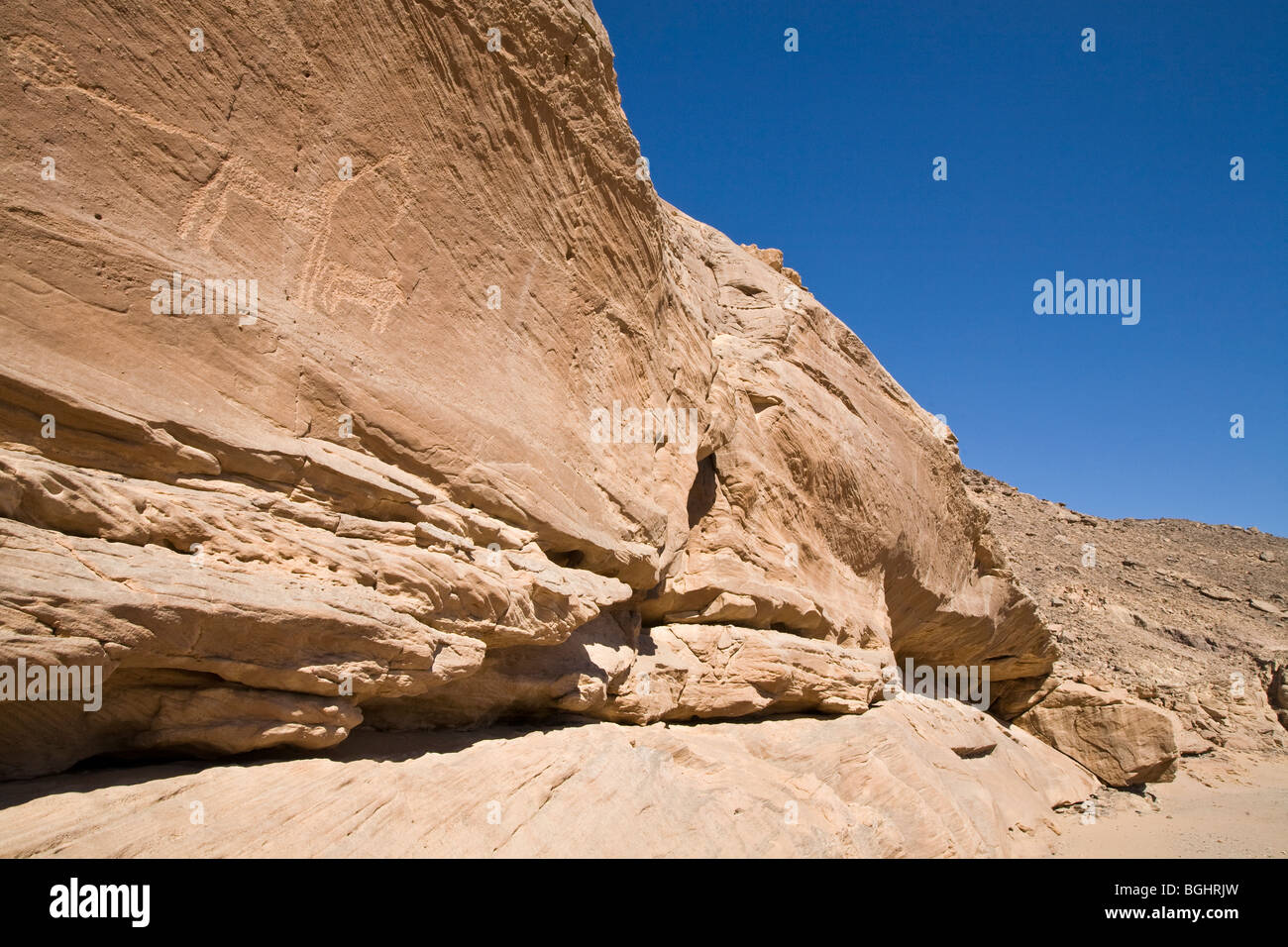 Wadi floor and cliff face showing ancient rock-art in the Eastern Desert of Egypt. Stock Photo