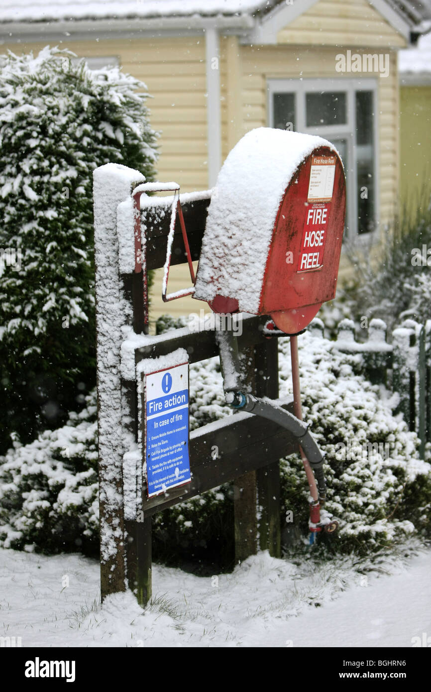 Fire Hose and reel covered in snow and ice Stock Photo
