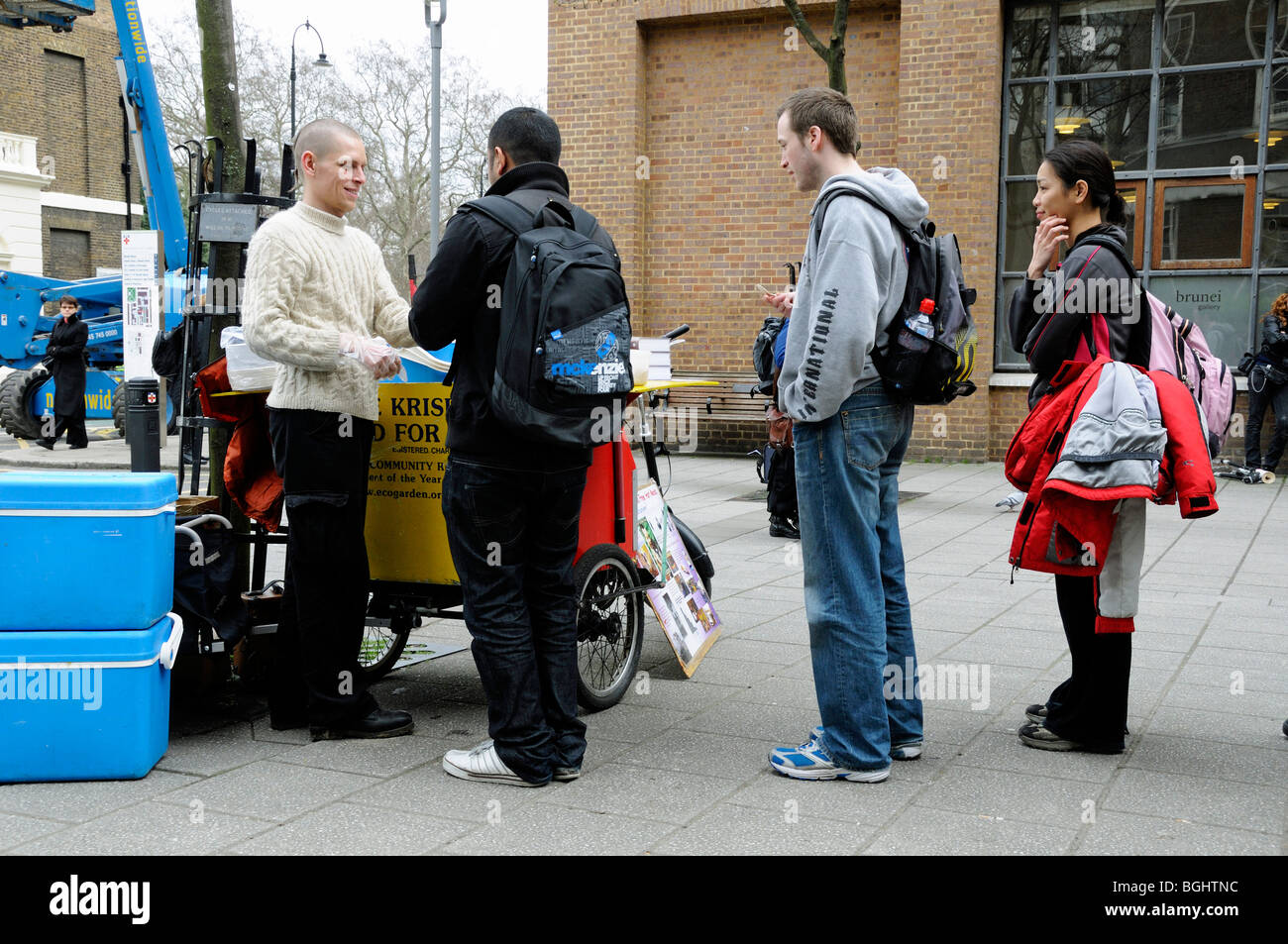 Man from the Hare Krishna Movement serving free food London England UK Stock Photo