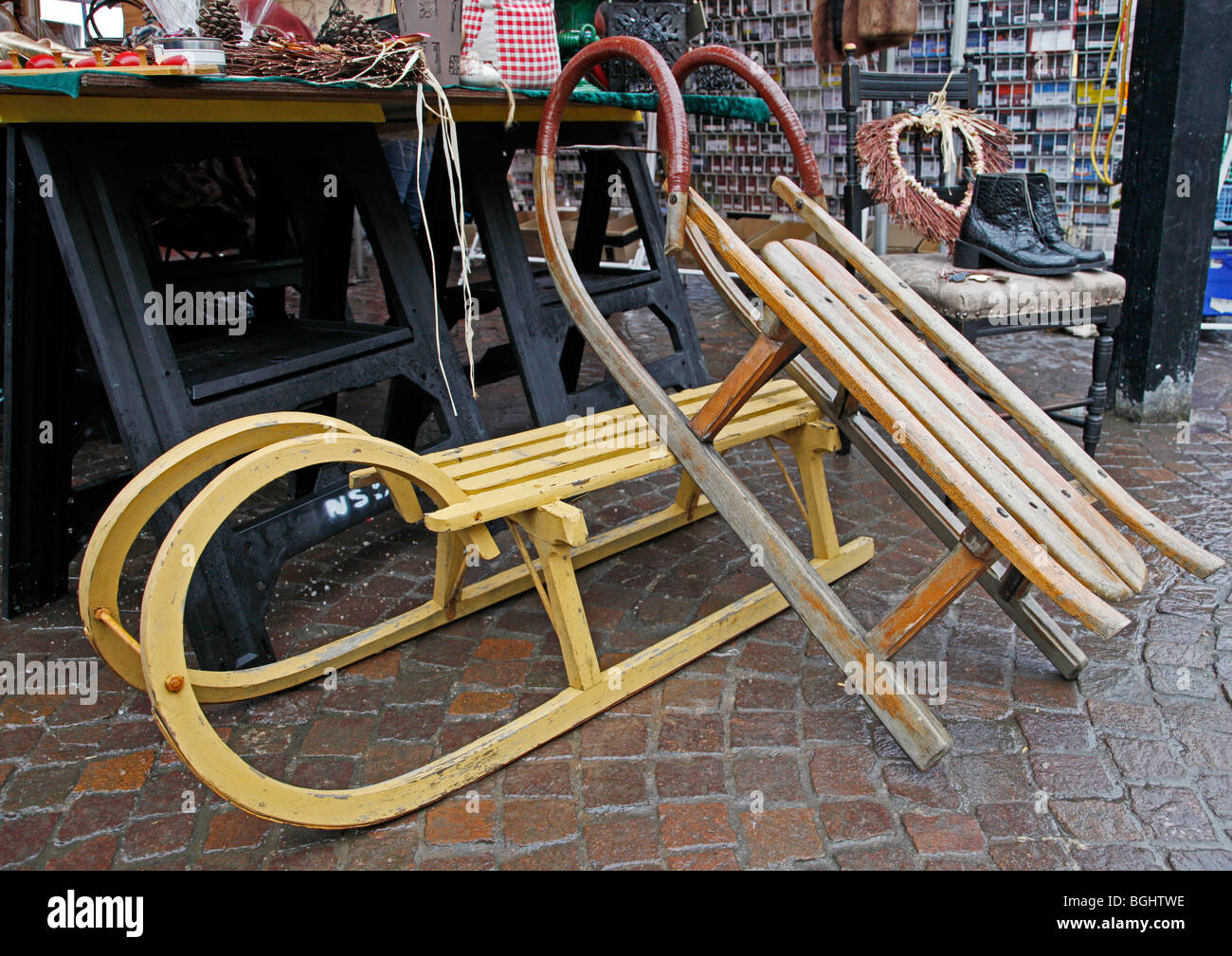 Two old fashioned sledges on sale at a market stall Stock Photo Alamy