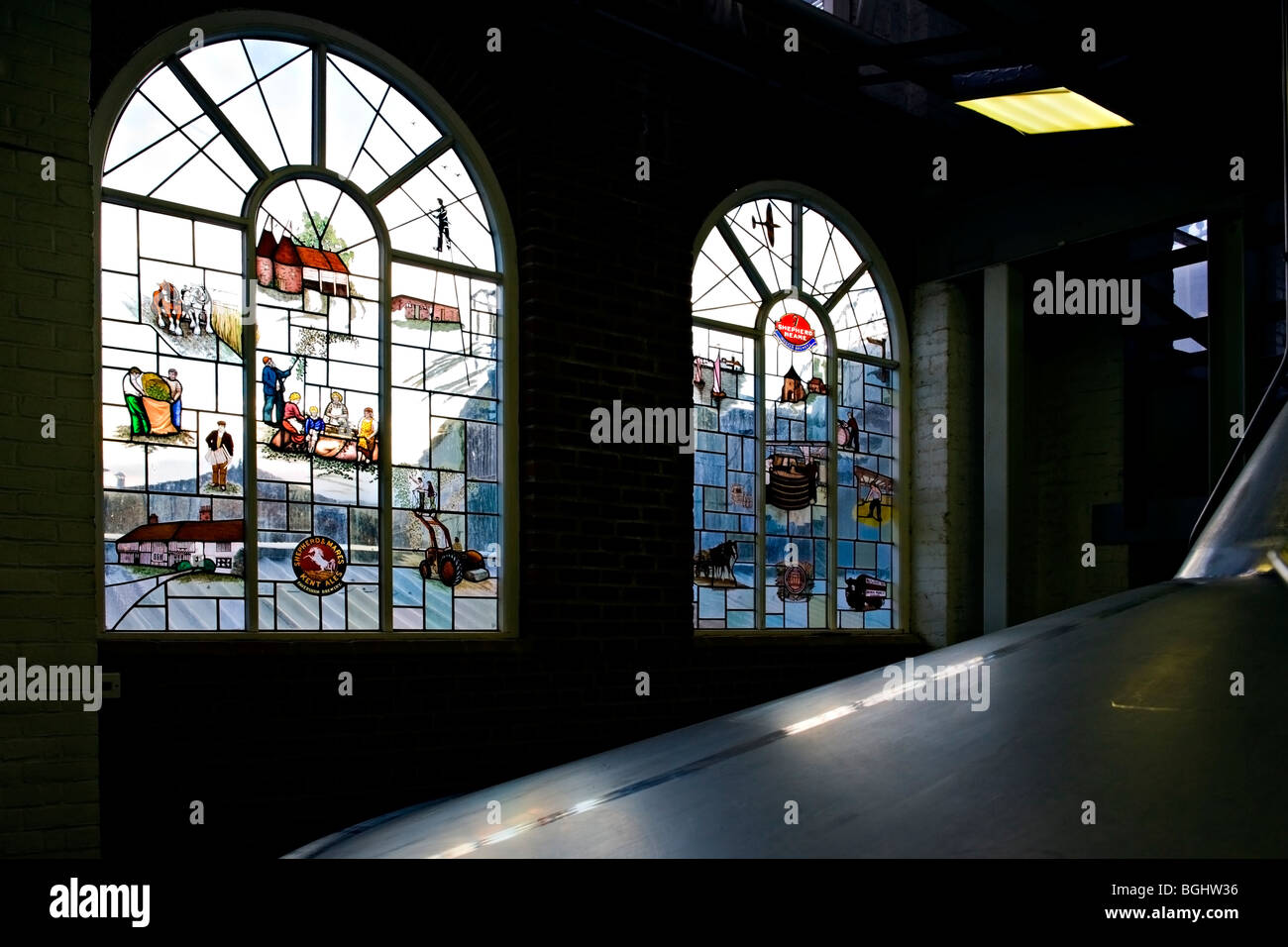 Stained glass windows depicting historical scenes at the Shepherd Neame