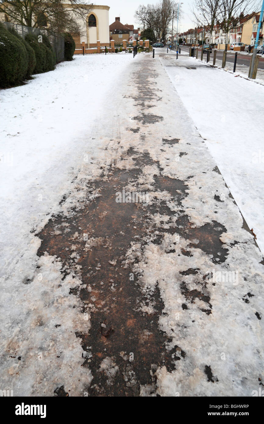 A partially gritted cleared footpath outside a school in Hounslow, Middx, UK during the January 2010 cold spell. Stock Photo