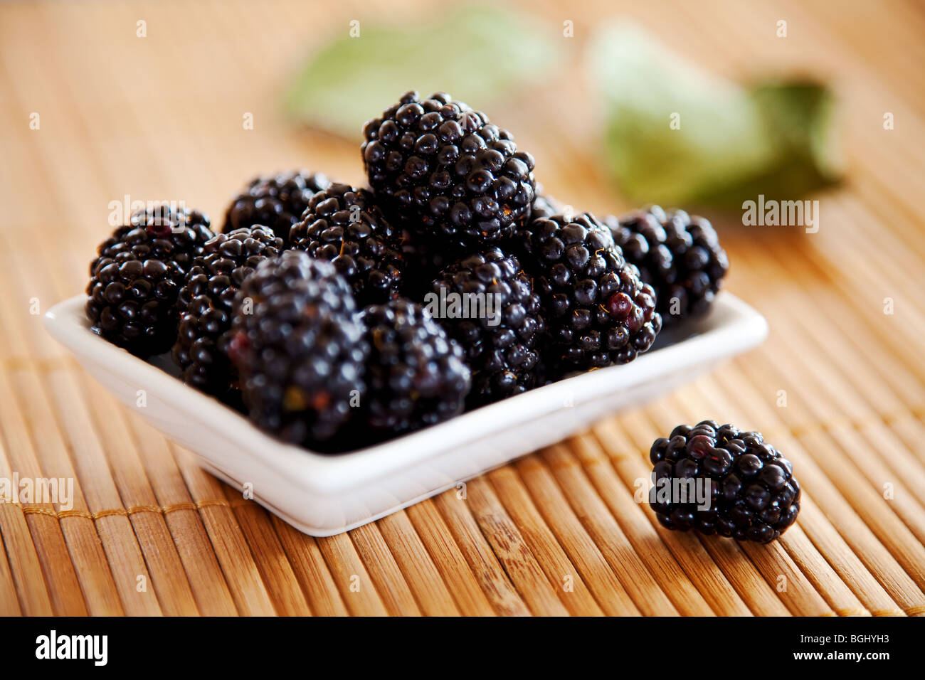 blackberries isolated on a bamboo mat background Stock Photo