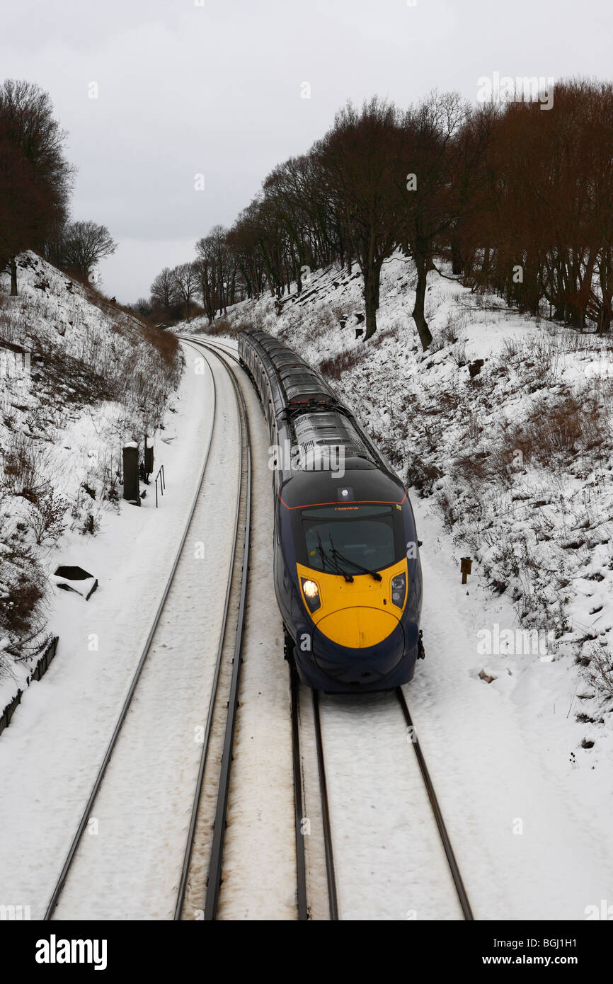 A high speed Hitachi Javelin train rushing through the snowy Kent