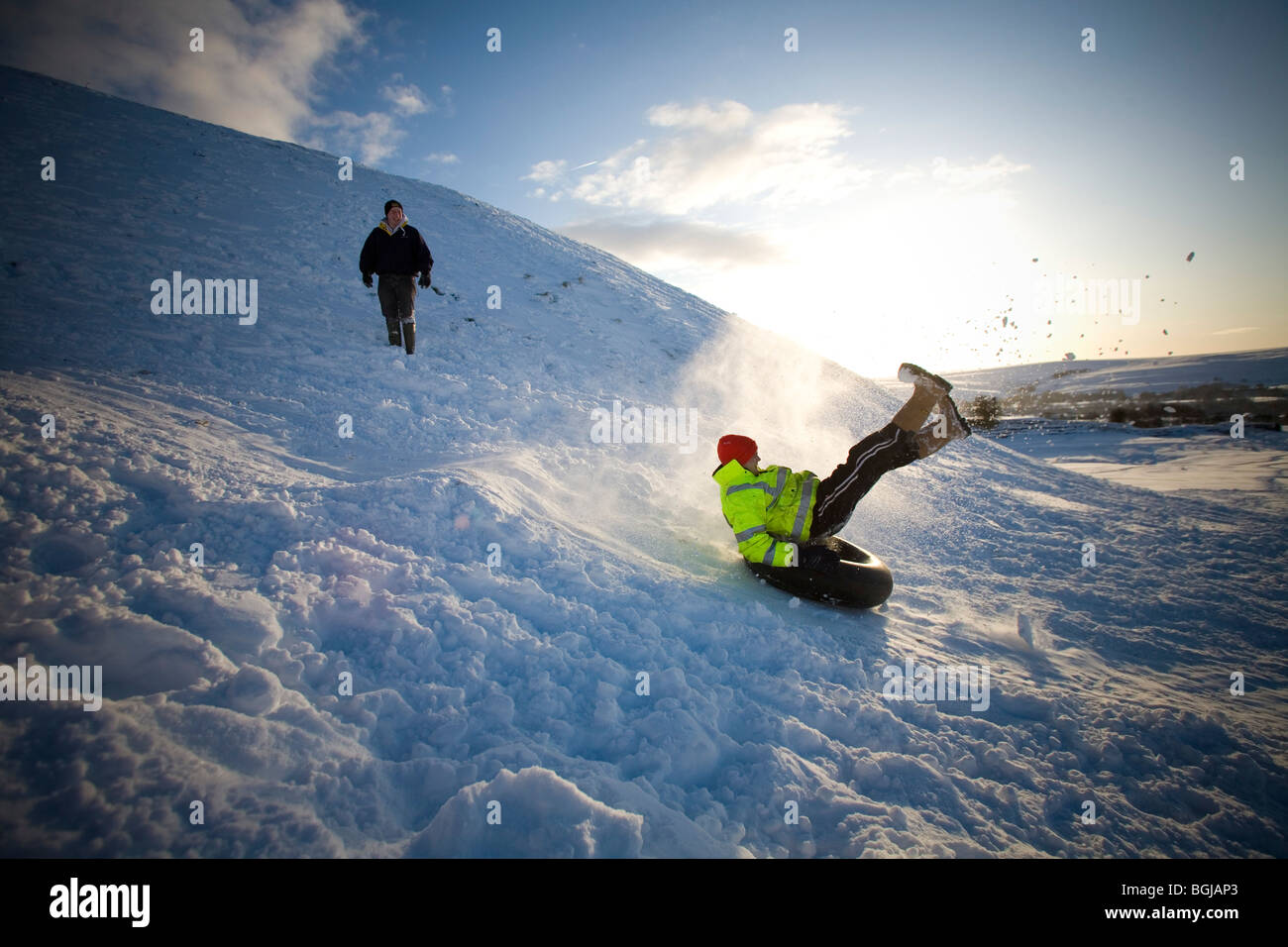 Sliding down a hill on a inner tube. sledging down a hill on a day off