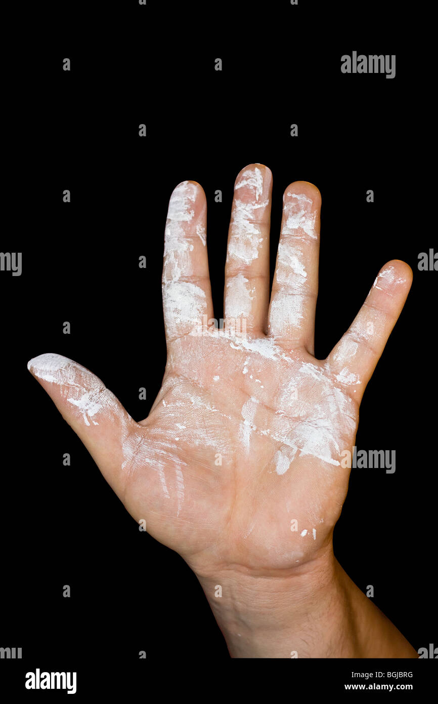 Cut Out. Man's hand with white paint on black background. Stock Photo