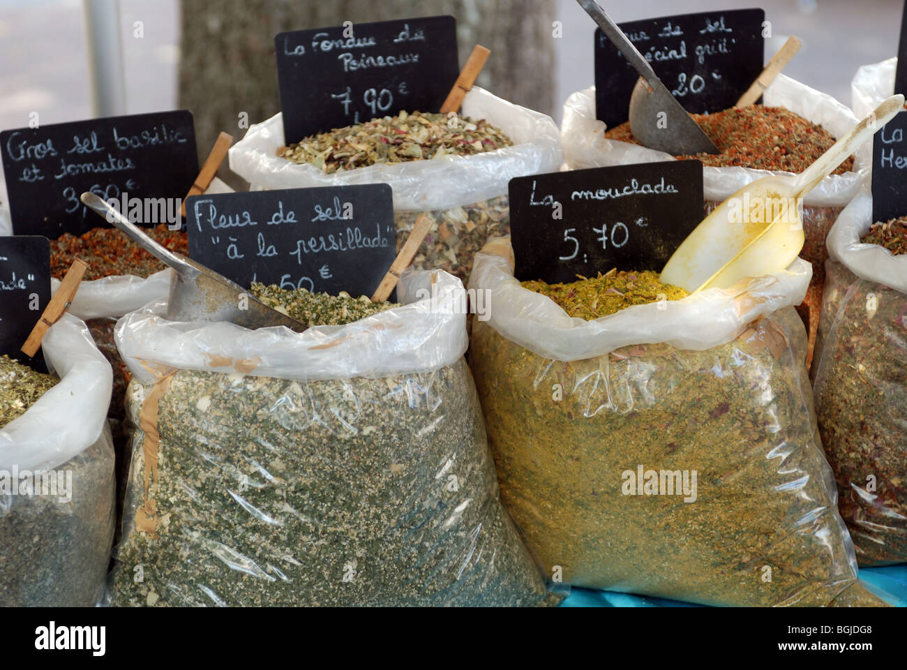 DRIED HERBS AND SPICES IN PLASTIC CONTAINERS ON STALL IN FRANCE Stock