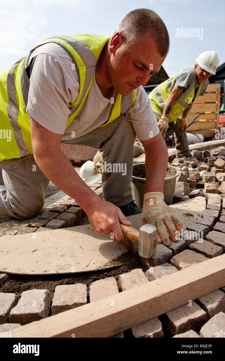 Modern cobblestone being laid Stock Photo
