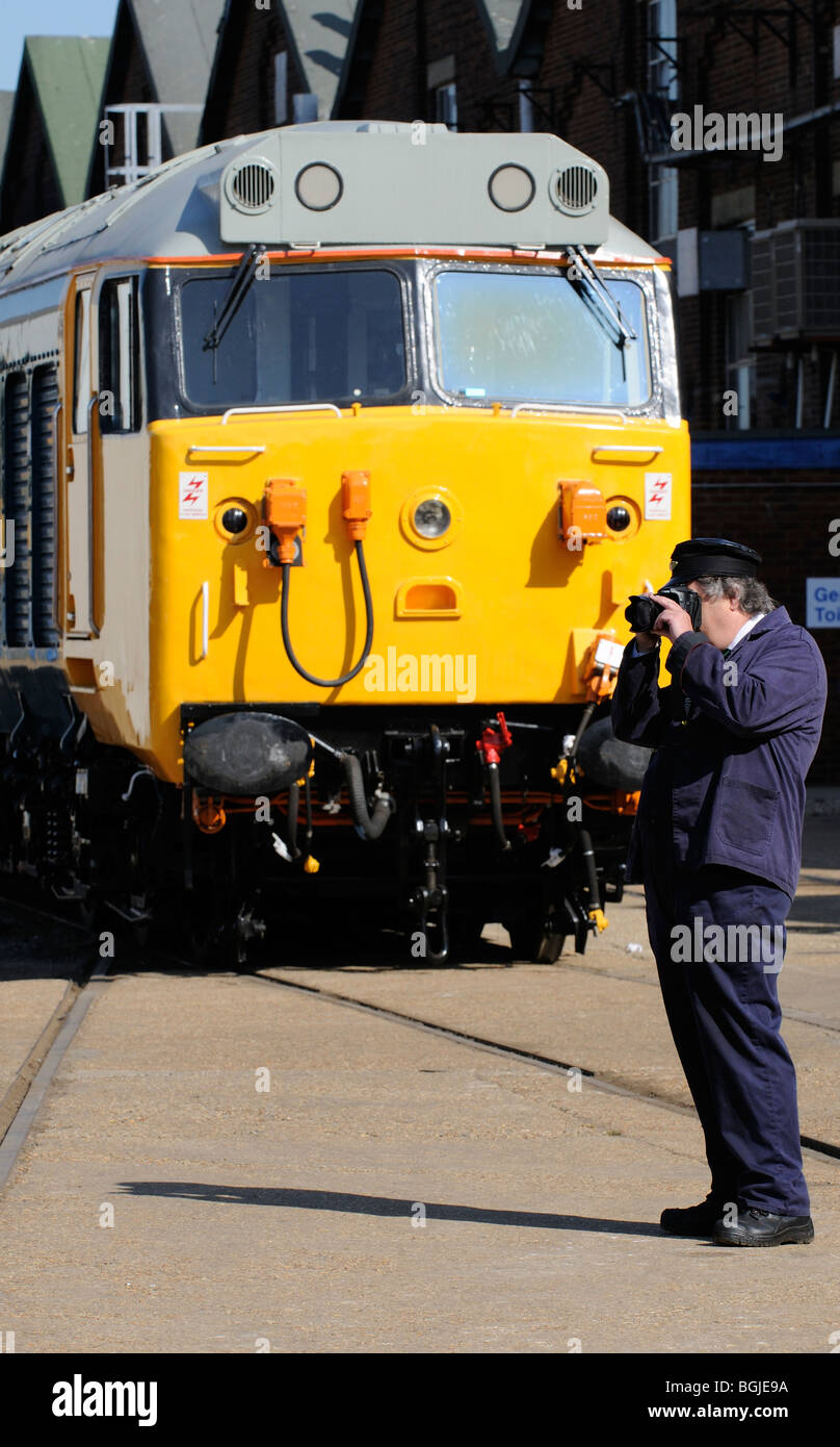 Railway train enthusiast and photographer taking pictures at an open day event at Eastleigh