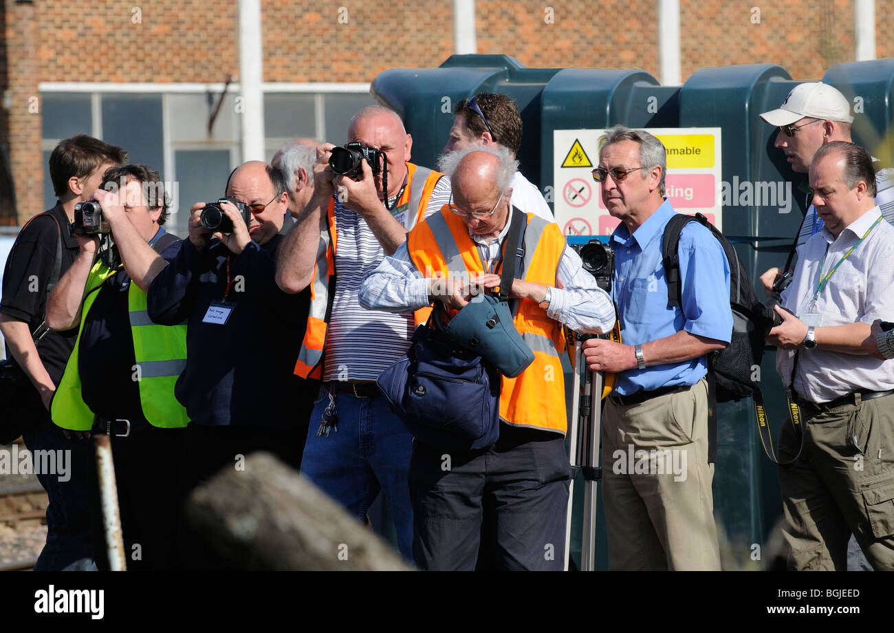 Group of railway train enthusiasts and photographers taking pictures at an open day event at Eastleigh Railway Works Stock Photo