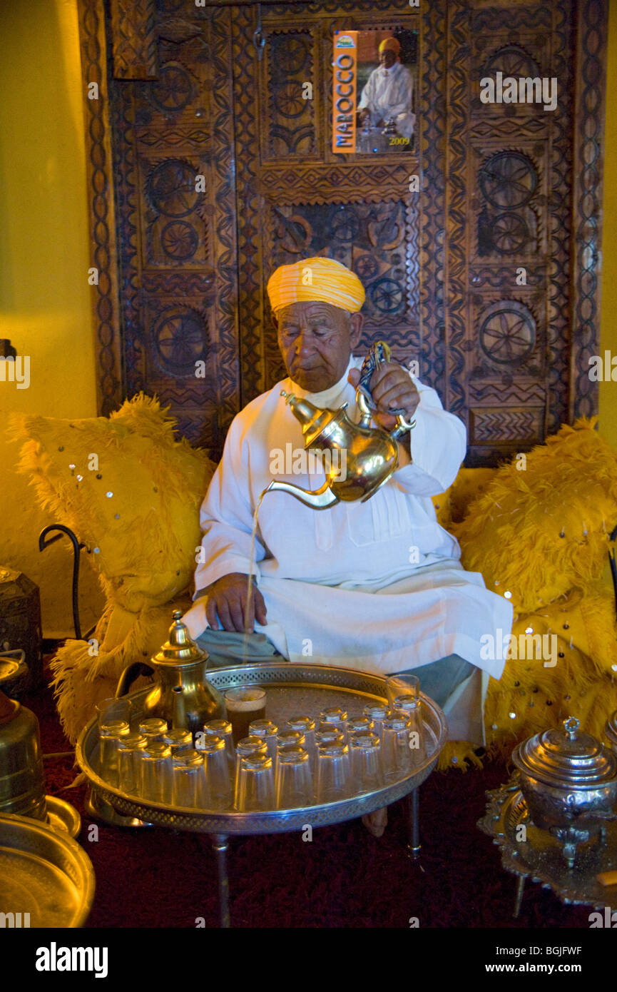 Habibi pouring glasses of mint tea in the reception area of Hotel Xaluca Maadid, Erfoud, Morocco. Stock Photo