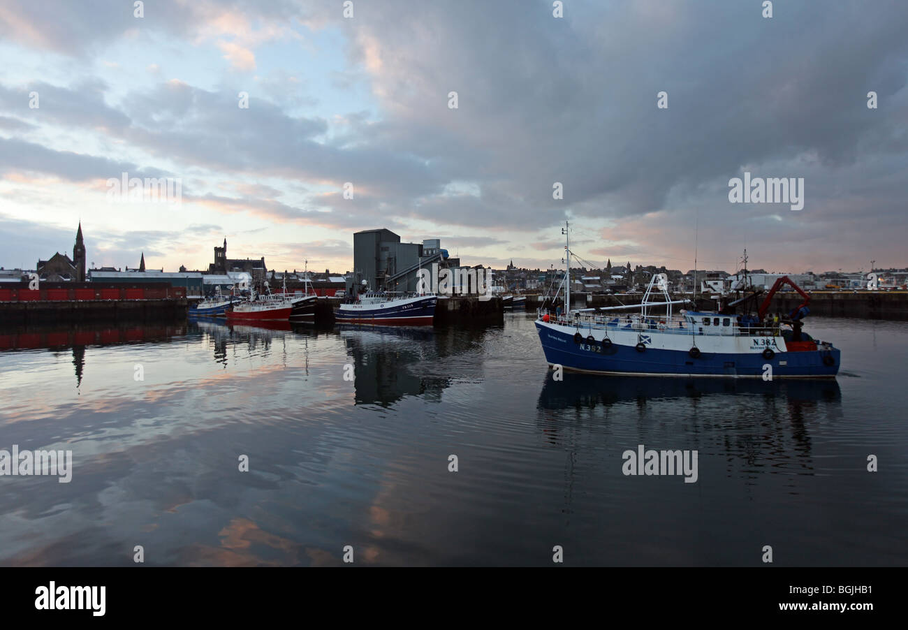 North Sea fishing trawlers berthed in Fraserburgh Harbour, Aberdeenshire, Scotland, UK, at sunset Stock Photo