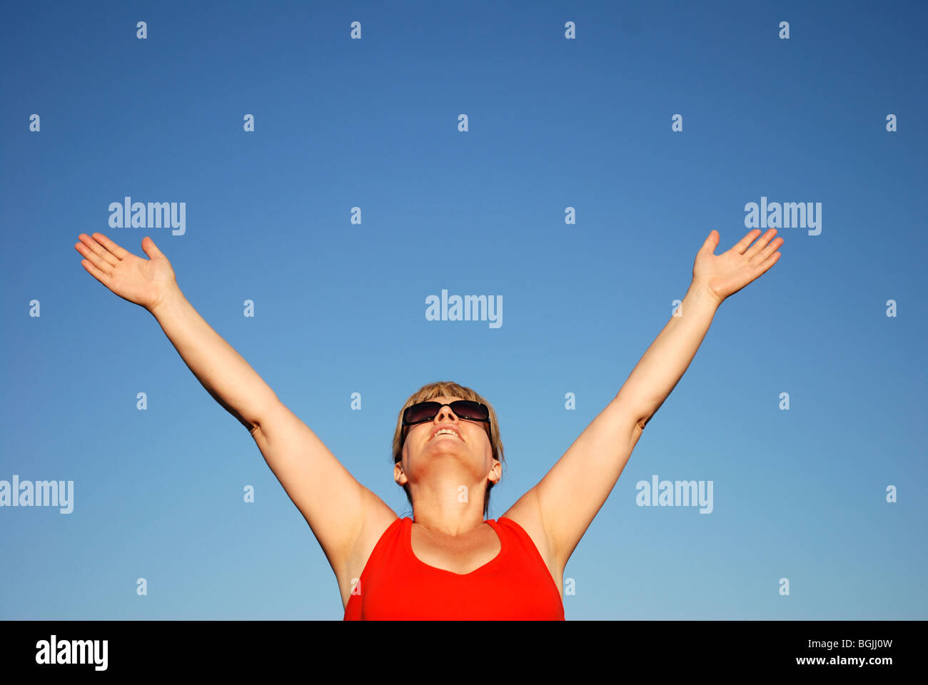 Mature woman outside with arms outstretched Stock Photo - Alamy