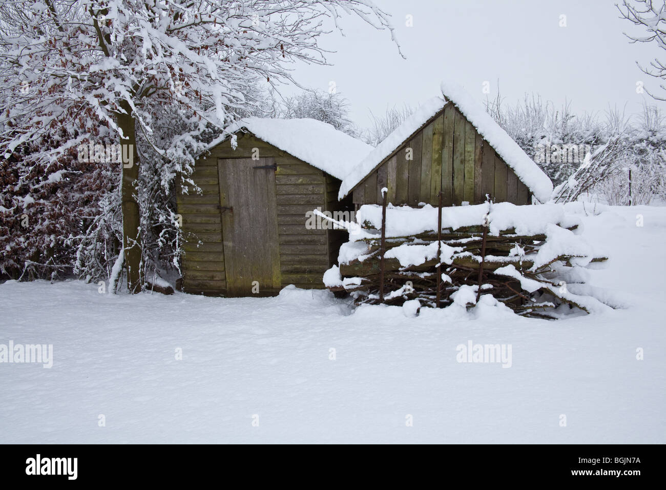 Snow covered wooden garden sheds, Hampshire , England. Stock Photo