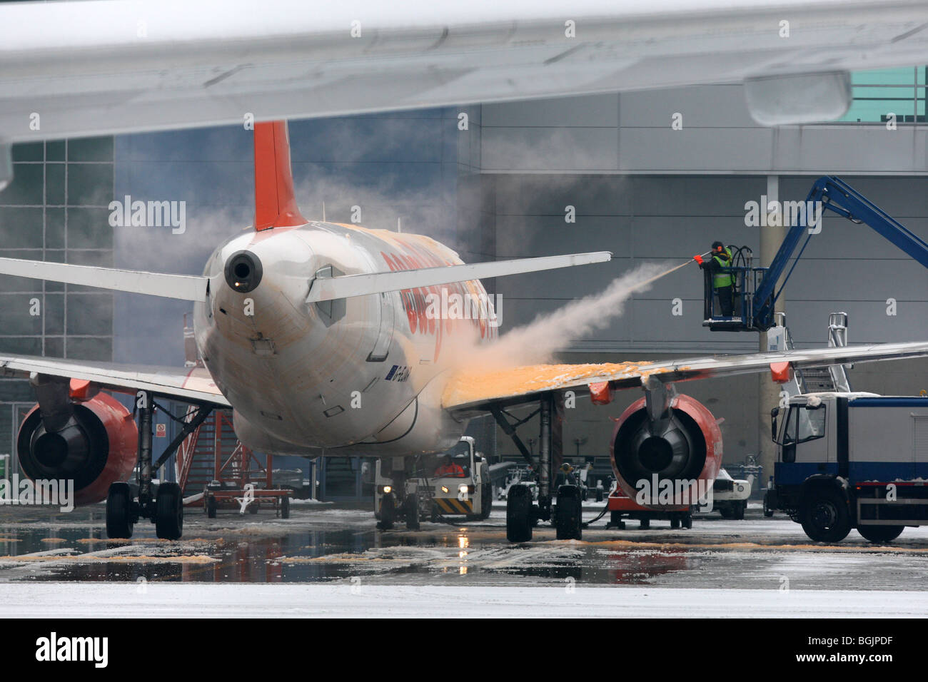AN EASYJET PLANE BEING SPRAYED WITH DE ICER AT LUTON AIRPORT