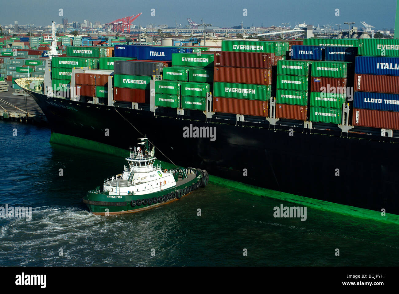 Container ship at dock with tugboat, Port of Los Angeles, California ...