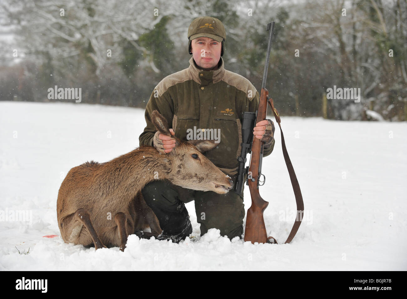 deer stalker with his shot red deer Stock Photo