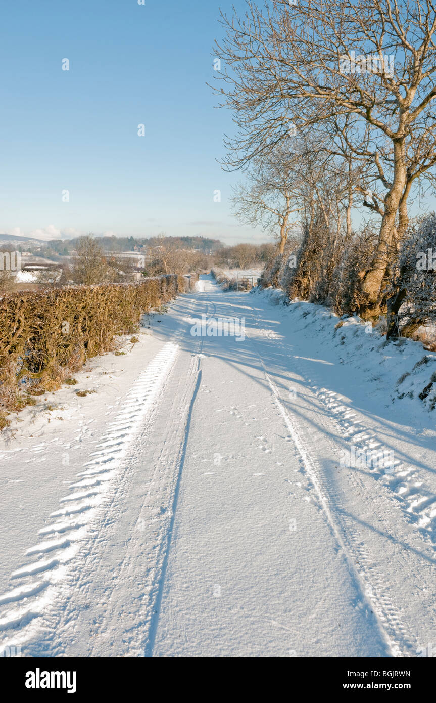 Snow covered rural lane, with tyre tracks Stock Photo
