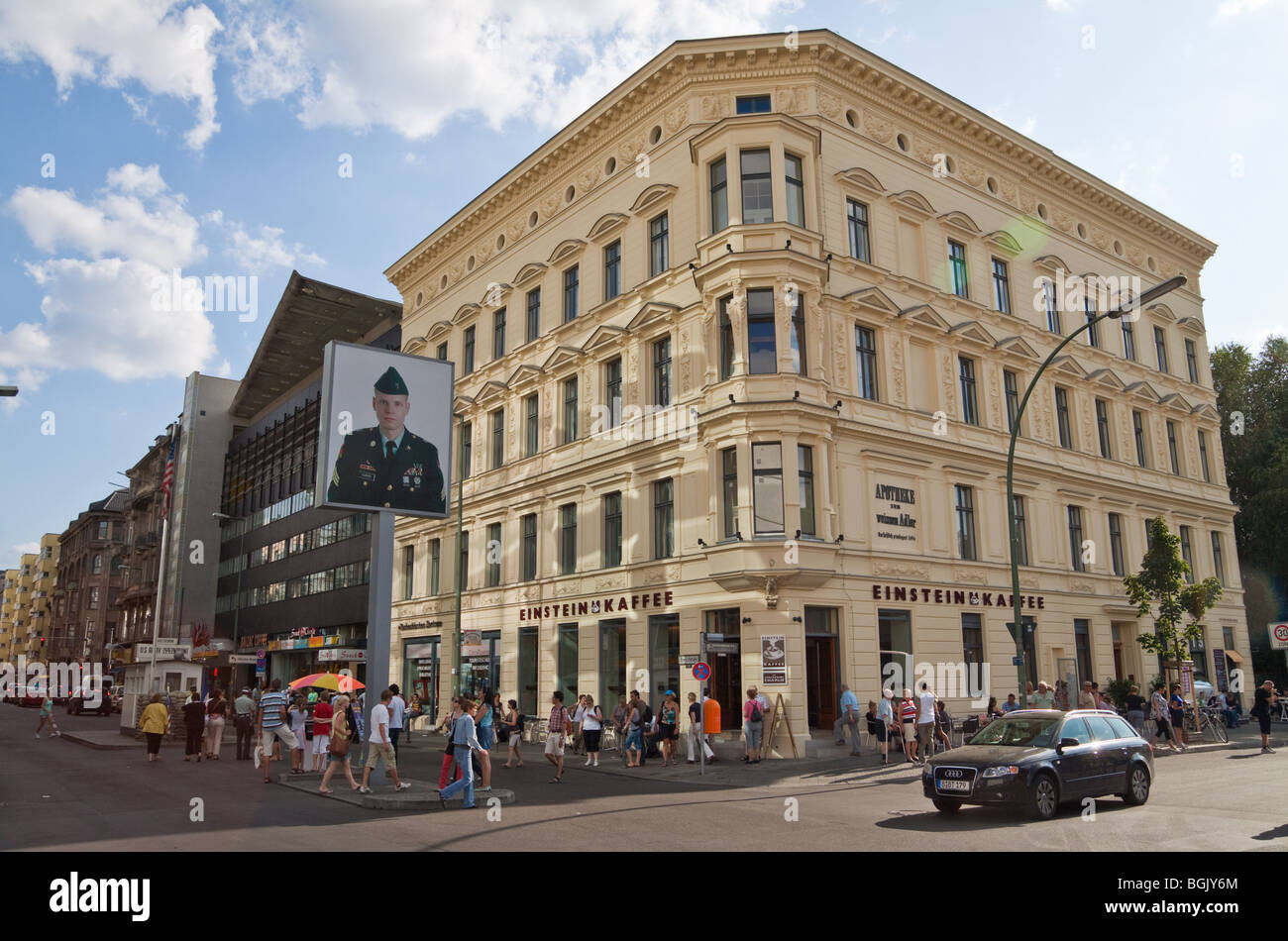 Checkpoint Charlie memorial site and Einstein Café viewed across the intersection of Friedrichstraße and Zimmerstraße, Berlin. Stock Photo