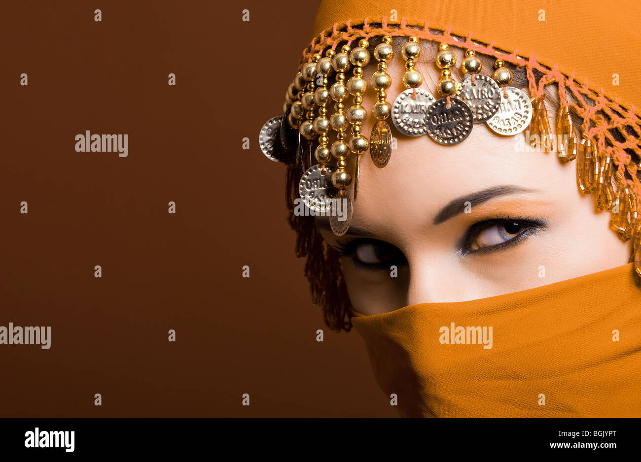 a beautiful woman wearing a red exotic veil Stock Photo