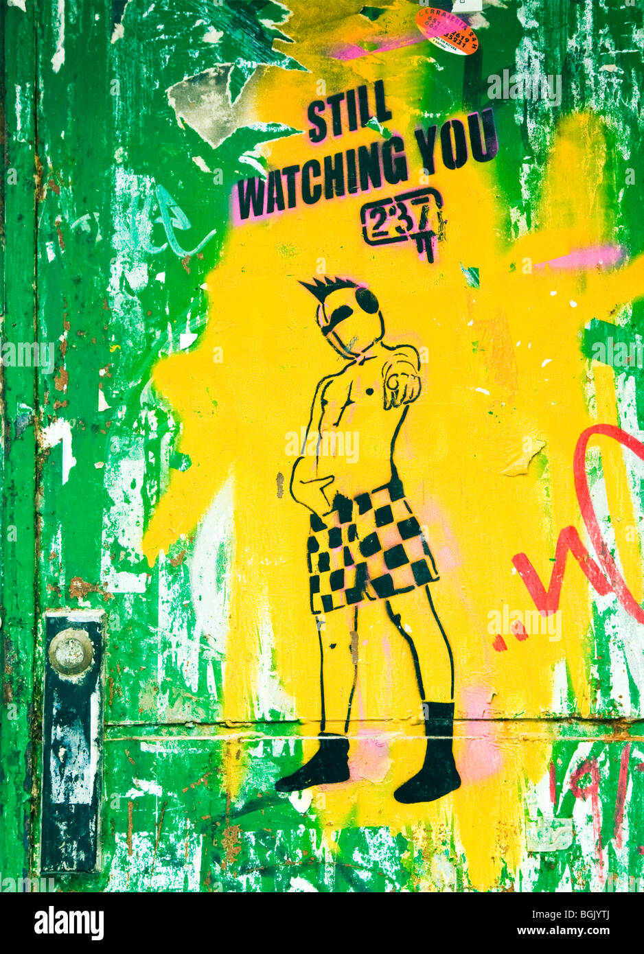 Street art on old door in Malaga, Malaga Province, Costa del Sol, Spain. A stencil with slogan Still Watching You 237 Stock Photo
