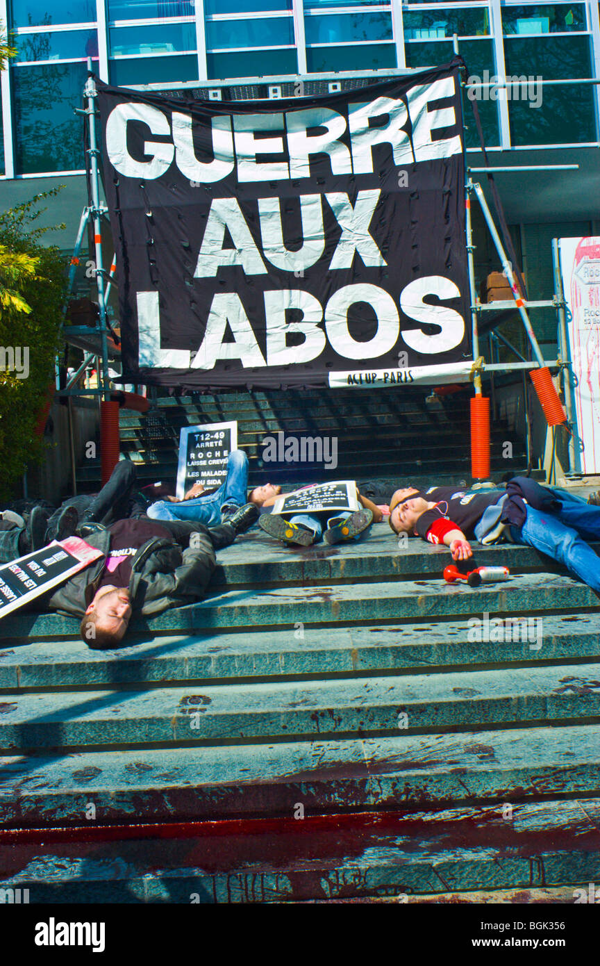 Paris, France - Group hiv AIDS Activists of Act Up-Paris Protesting Against Pharmaceutical Corporation, Roche, big pharma protests, act up poster, Laying Down, Die-in Stock Photo