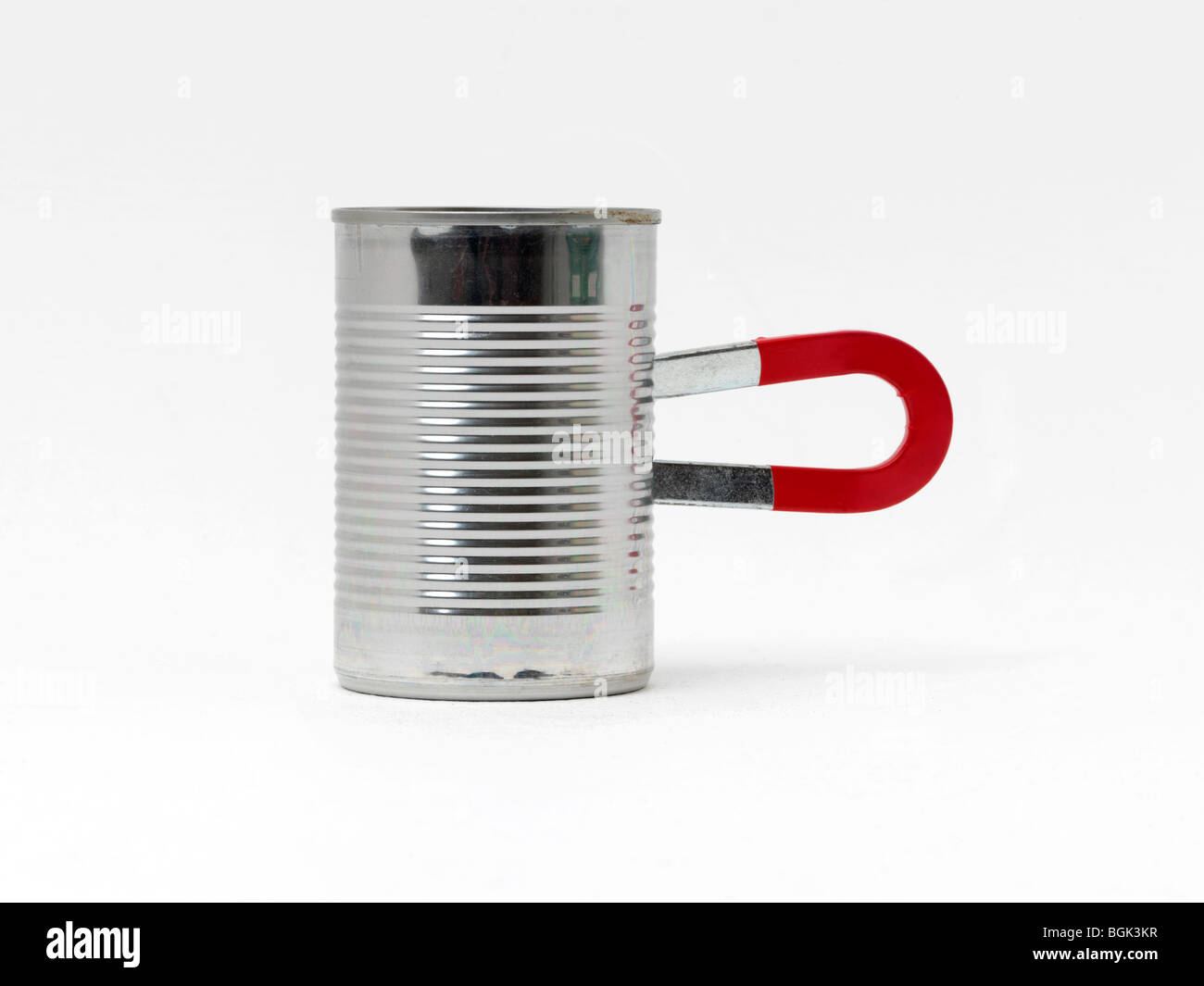 A Horseshoe Magnet attached to a can Stock Photo