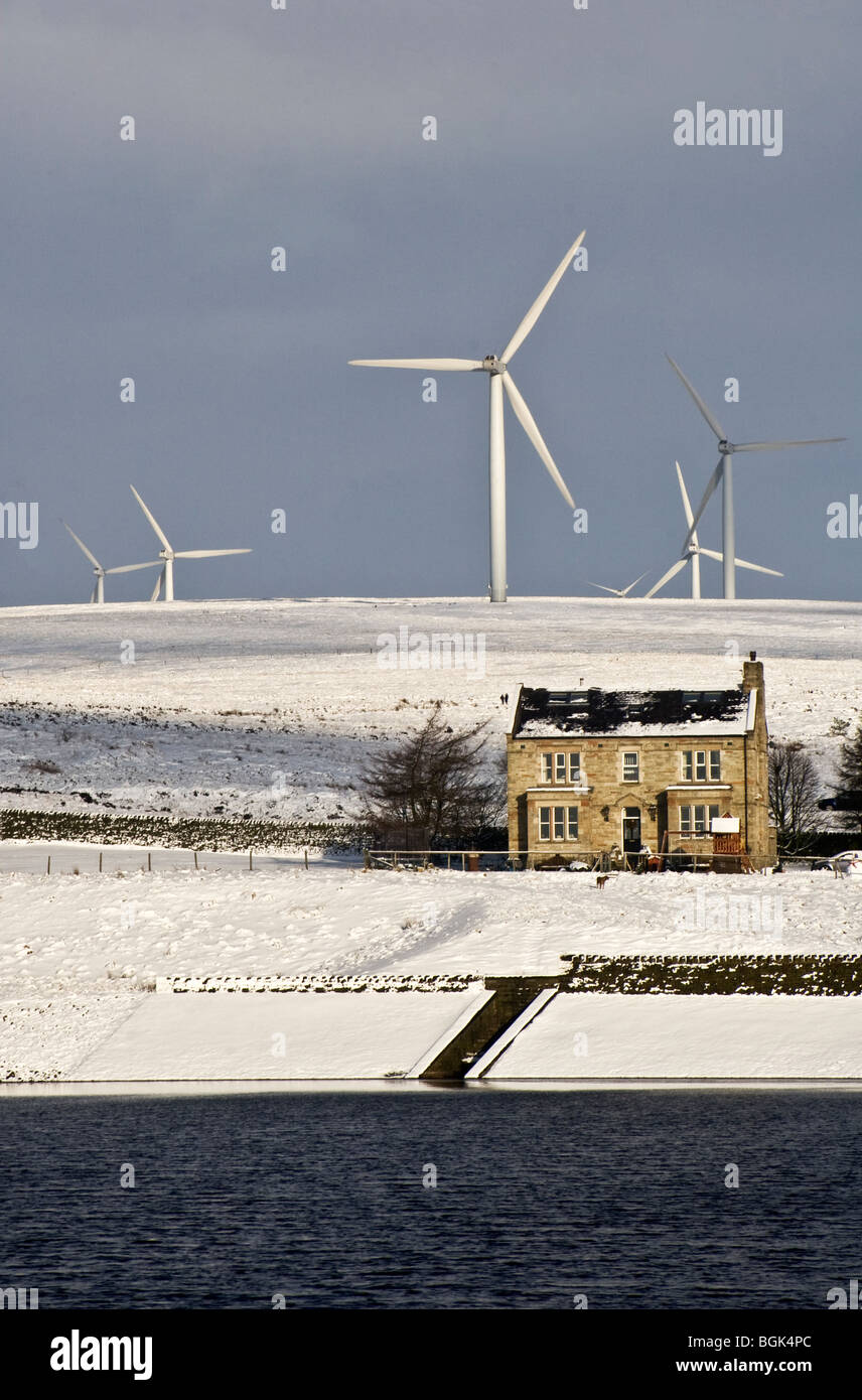 Wind turbines on Scout Moor, Ashworth Reservoir and house, winter, Lancashire, UK.  (Mixed northern upland land uses) Stock Photo