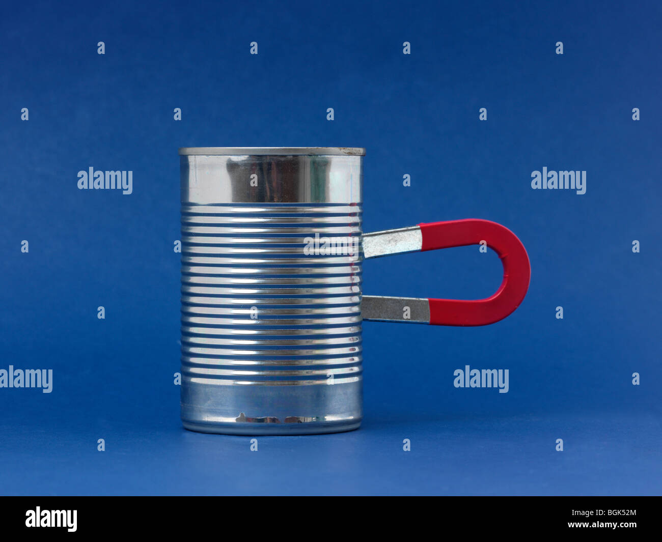 A Horseshoe Magnet attached to a can Stock Photo