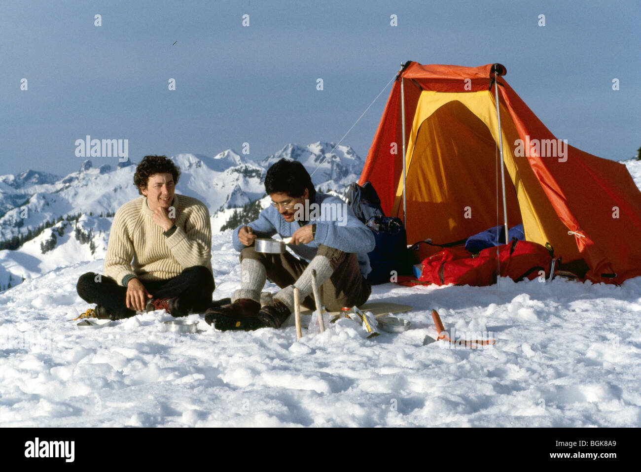 Wilderness Tent Camping in Snow, Campers eating Alpine Lunch on Sky