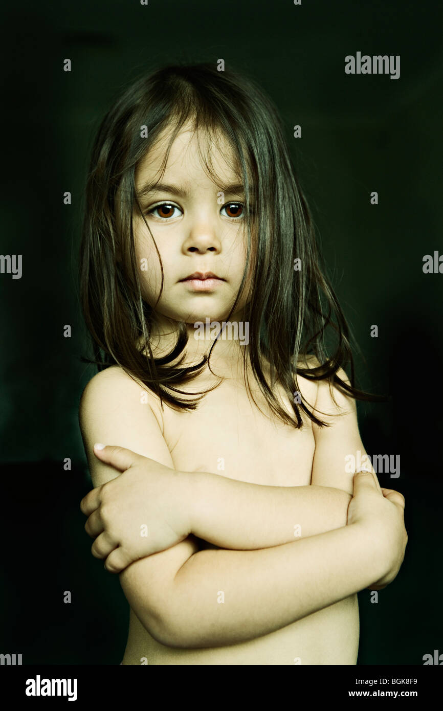 Three year old girl with arms crossed Stock Photo