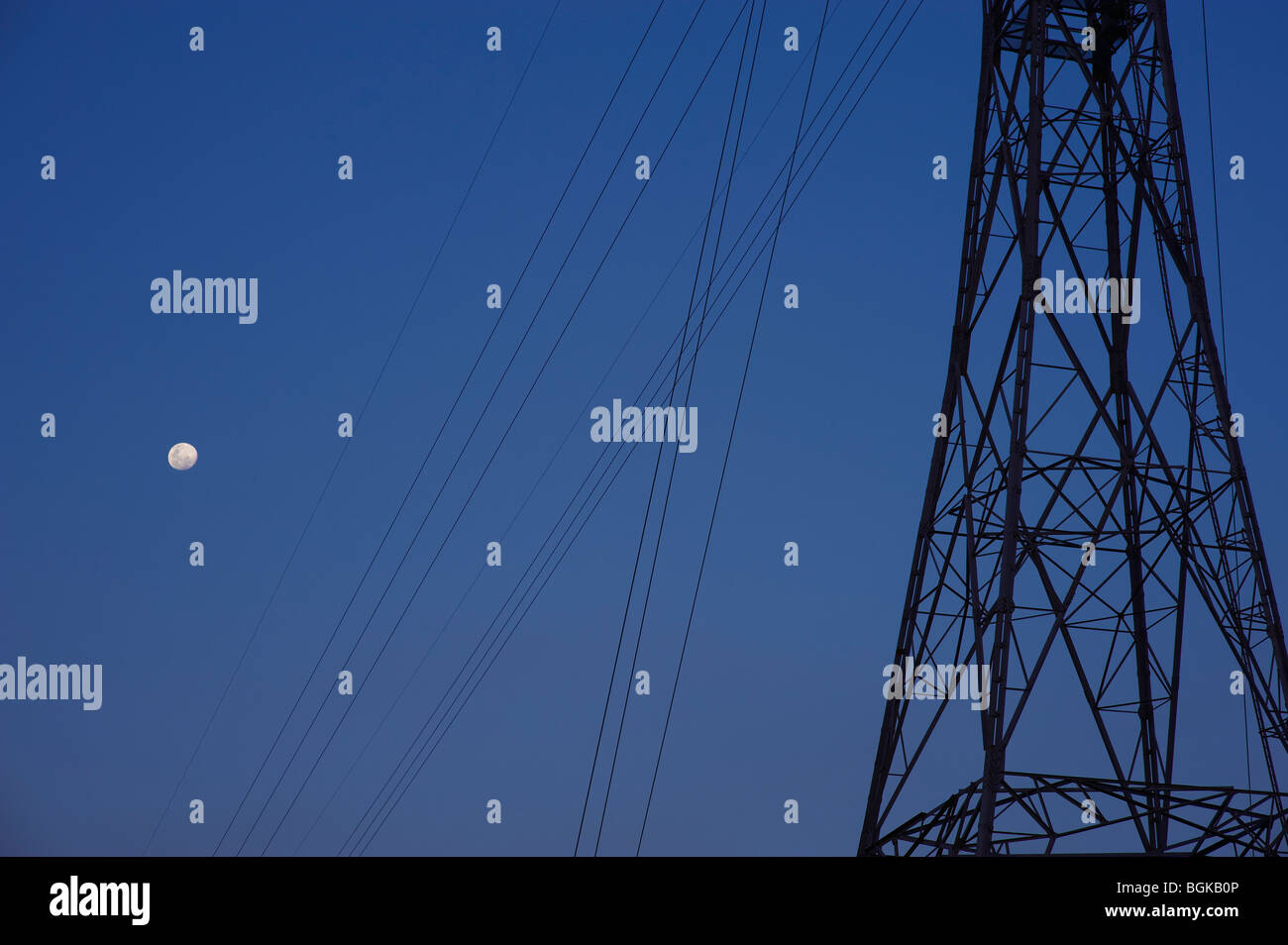 Electricity pylons and full moon Stock Photo