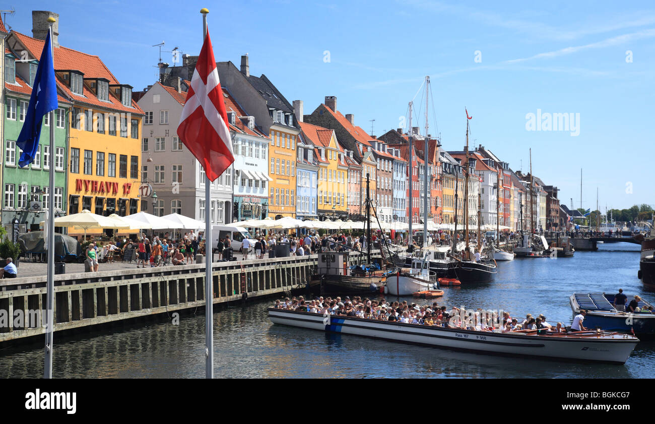 Tourists in boat and colourful houses at Nyhavn, Copenhagen, Denmark Stock Photo