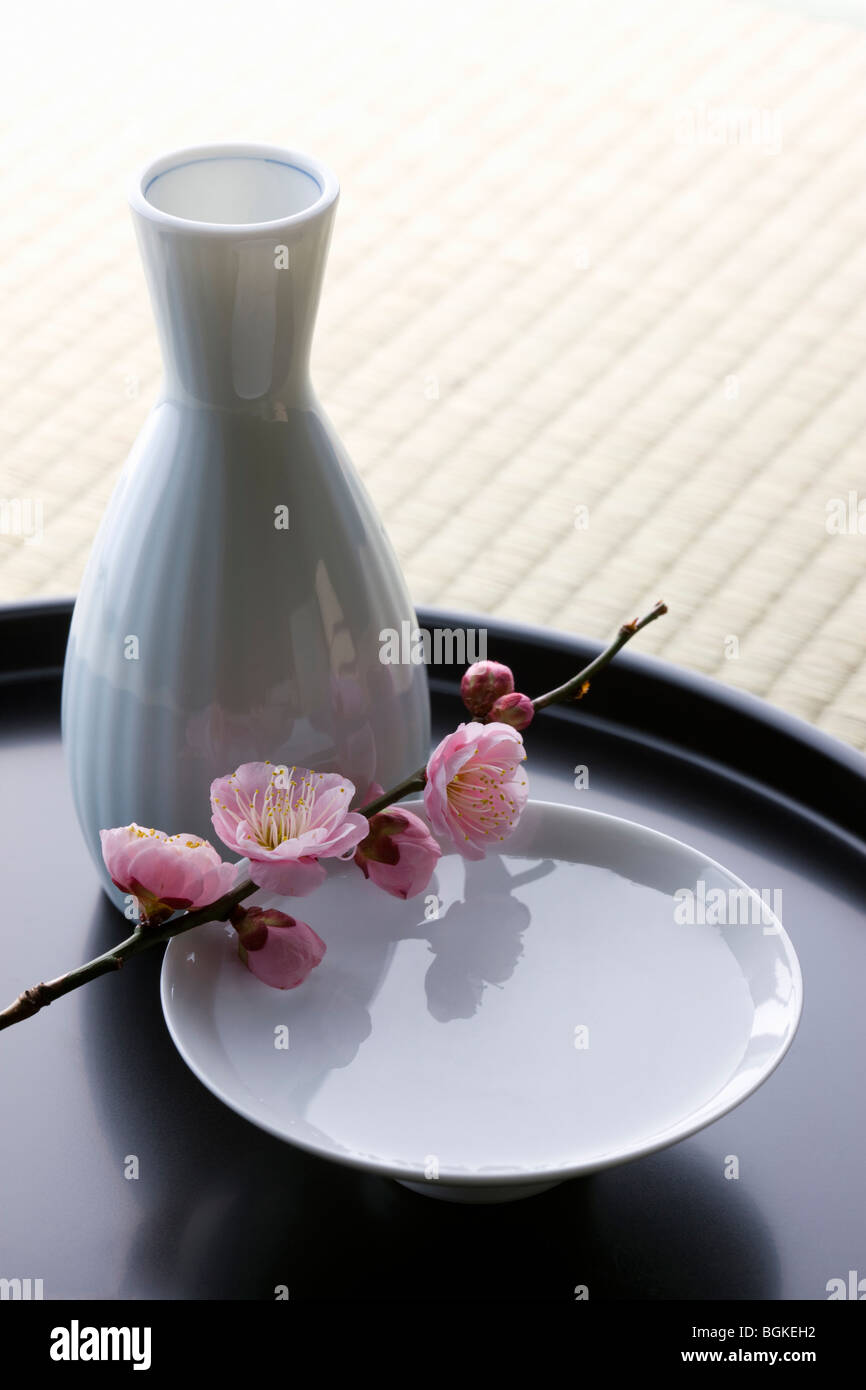 Sake and plum blossoms Stock Photo