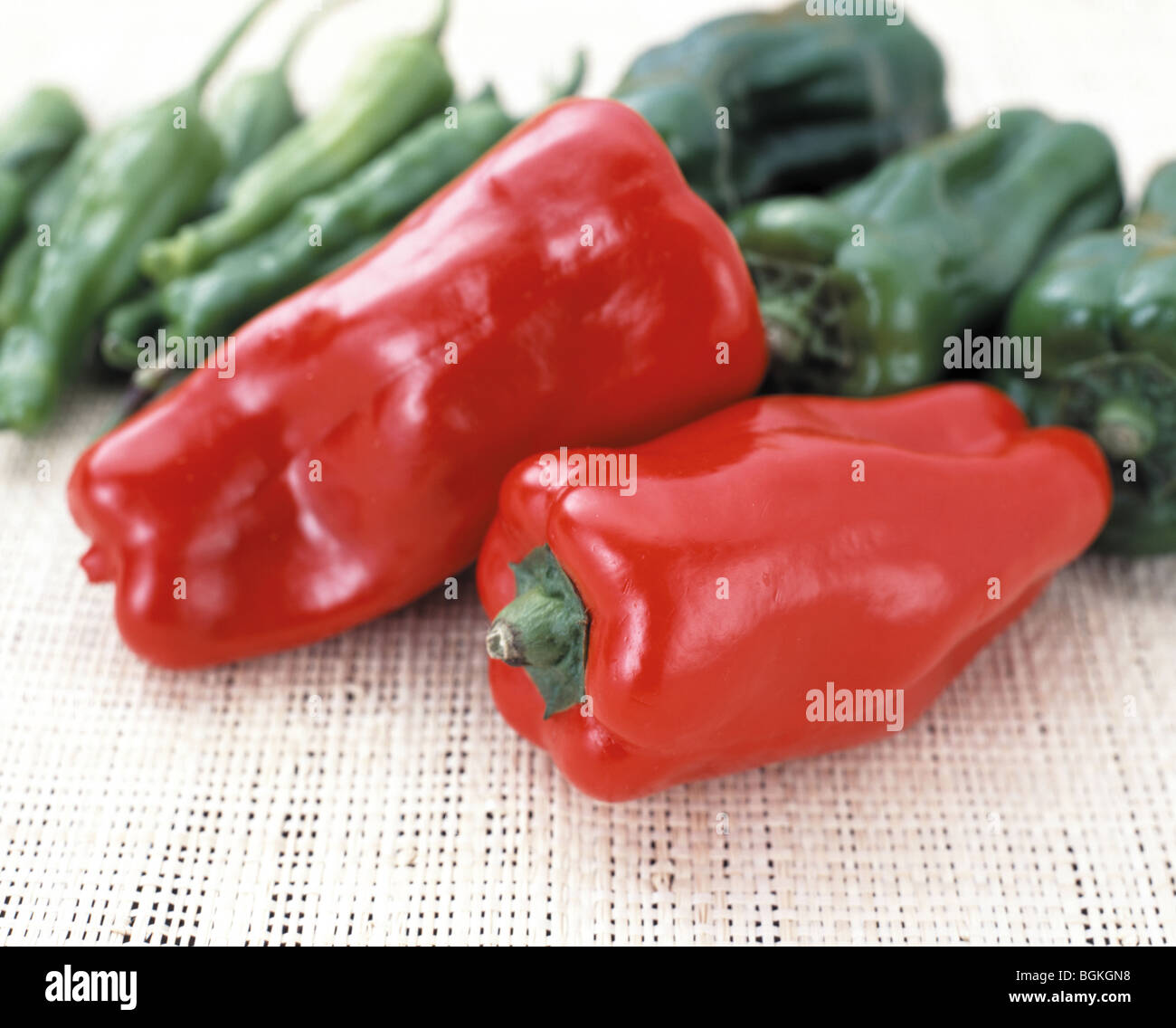 Red and green bell peppers white background Stock Photo - Alamy