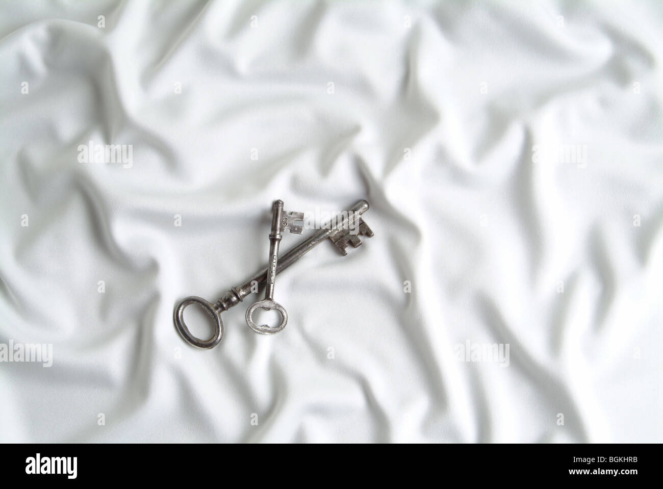 Keys On White Silk Stock Photo Alamy