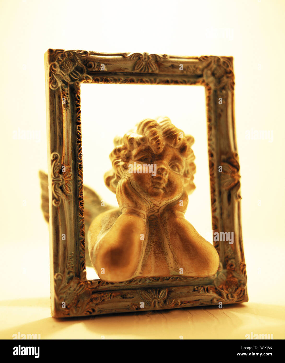 Cherub figurine in picture frame Stock Photo