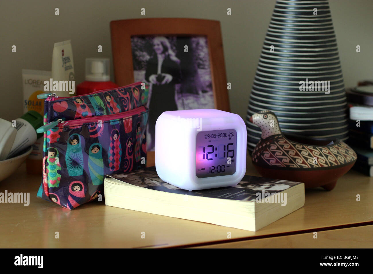 Alarm clock on a bedside table Stock Photo