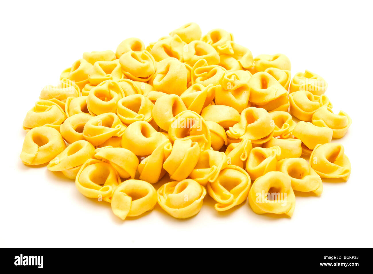 Tortellini (ring-shaped pasta) on a white background Stock Photo